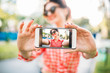 © Nomad_Soul - Pinup girl shows on phone outdoors selfie