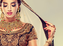 Portrait Of Beautiful Indian Girl. Young Hindu Woman Model With Golden Kundan Jewelry Set . Traditional Indian Costume Lehenga Choli . 
