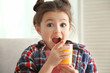 © Africa Studio - Cute little girl with glass of juice at home