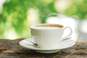 Wall Mural - Stock Photo - White Coffee Cup on brown old wooden table with bokeh