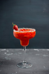 Wall Mural - Cocktail strawberry margarita on the wooden background. Selective focus.