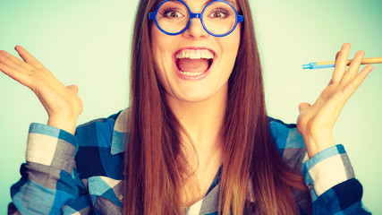 Poster - Happy nerdy woman in glasses holding pen