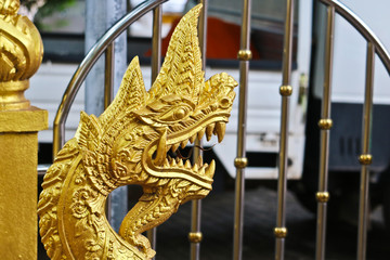 Wall Mural - Golden Naga ladder sculpture in Lao temple, Laos