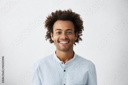 Positive Guy With African Hairstyle And Dark Skin Wearing