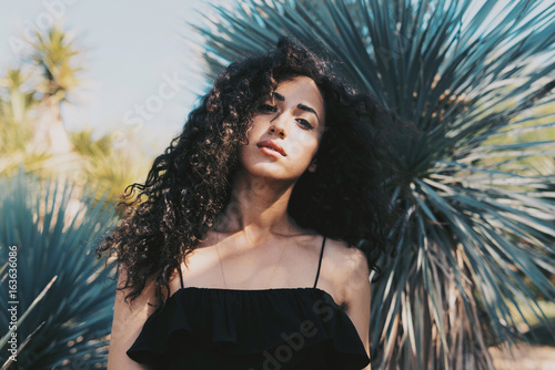 A Brunette Girl Is Looking At The Camera While Standing
