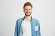 © Cookie Studio - Portrait of young handsome hipster man with beard smiling laughing looking at camera over white background.