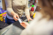 © Karanov images - Woman paying with a credit card in a supermarket closeup