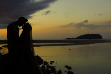 Kissing Couple In Shilloutte Over Sunset Background