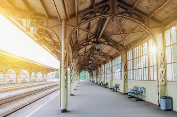 Vintage retro platform passenger railway station. Concept of meeting, waiting, seeing people on the road trip