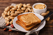© aperturesound - Peanut butter sandwich on plate with inshell peanuts