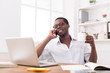 © Prostock-studio - Relaxed young black businessman call mobile phone in modern white office