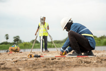 survey engineer in construction site use theodolite mark a concrete pile co ordinate