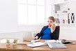© Prostock-studio - Pregnant business lady at work talking on phone