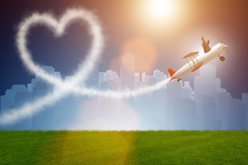 Wall Mural - Man flying airplane and making heart shape