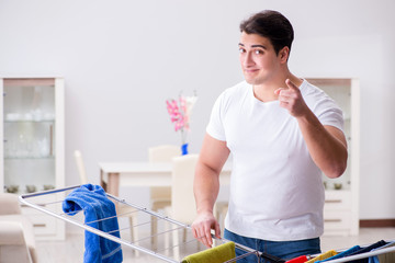 Wall Mural - Man doing laundry at home