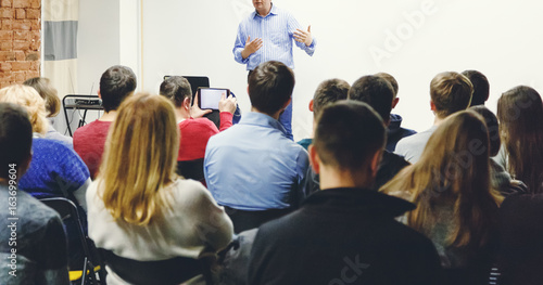 Fotografía Adult students listen to professor's lecture in small class room