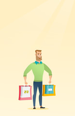 Poster - Young happy caucasian man with shopping bags.