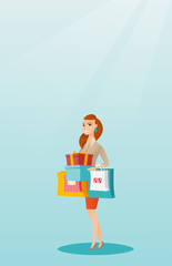 Wall Mural - Woman holding shopping bags and gift boxes.