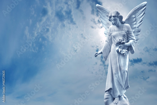 Foto Guardian Angel sculpture over bright sky