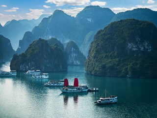 Viewpoint over Halong Bay with cruise ships in the ocean, Southeast Asia. UNESCO World Heritage Site. Beautiful scenery with sea and mountains, most popular landmark, tourist destination of Vietnam.