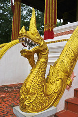 Wall Mural - Golden Naga ladder sculpture in Lao temple, Laos