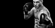 © Mike Orlov - Sportsman muay thai boxer fighting in boxing cage. Isolated on black background with copy Space. Black and white photo. Sport concept.