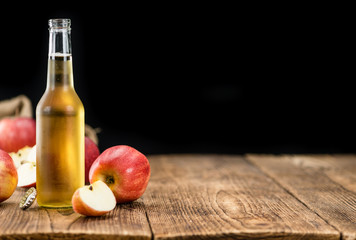 apple cider (selective focus) on vintage wooden background