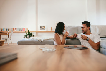 Wall Mural - Young couple having coffee at home