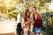 © Jacob Lund - College students using mobile phone outdoors on road