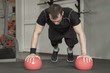 © lenblr - Fitness man doing push-ups exercise on the ball in gym