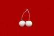 © Connect Images - Cherries painted white on red background