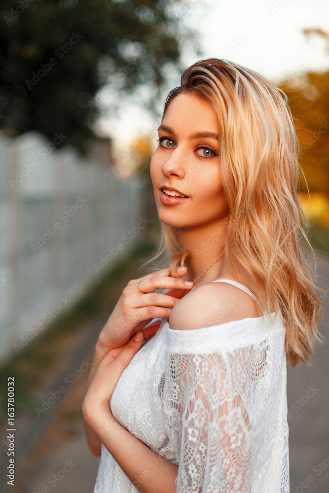 princess polly baby blue dress Portrait of a beautiful happy american blonde woman with blue eyes in a  vintage lace dress on a sunny day Stock Photo