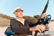 © Sergey Nivens - Senior man fishing at sea side