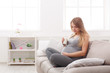 © Prostock-studio - Pregnant woman drinking glass of milk copy space