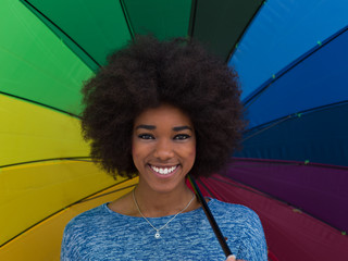 Poster - african american woman holding a colorful umbrella