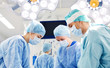 © Syda Productions - group of surgeons in operating room at hospital