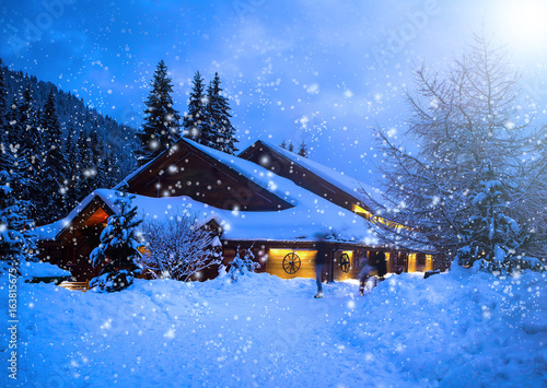 Obraz na plátně A fairy-tale house in the woods amid the snow-covered fir trees, Christmas landscape