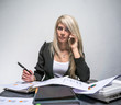 © Artem Markin - Beautiful blonde thoughtful businesswoman talk phone in office portrait.