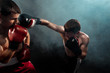 © master1305 - Two professional boxer boxing on black smoky background,