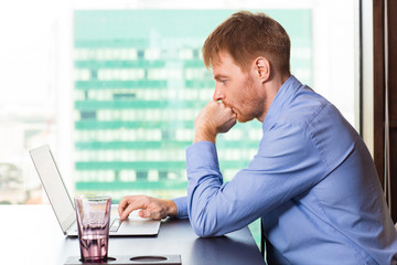 Wall Mural - Pensive young businessman immersed in work