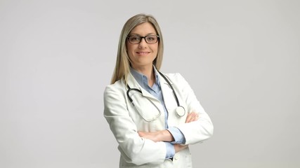 Wall Mural - Female doctor smiling and folding her arms