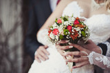 Fototapeta Morze - Bride holding big wedding bouquet on wedding ceremony