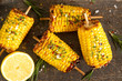 Corn grilled with salt and spices. Dark background. Fast food in the summer.