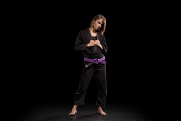 girl in black kimono posing on black background