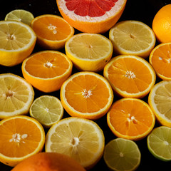 Citrus fruit background with sliced oranges lemons lime tangerines and grapefruit as a symbol of healthy eating and immune system boost with natural vitamins.