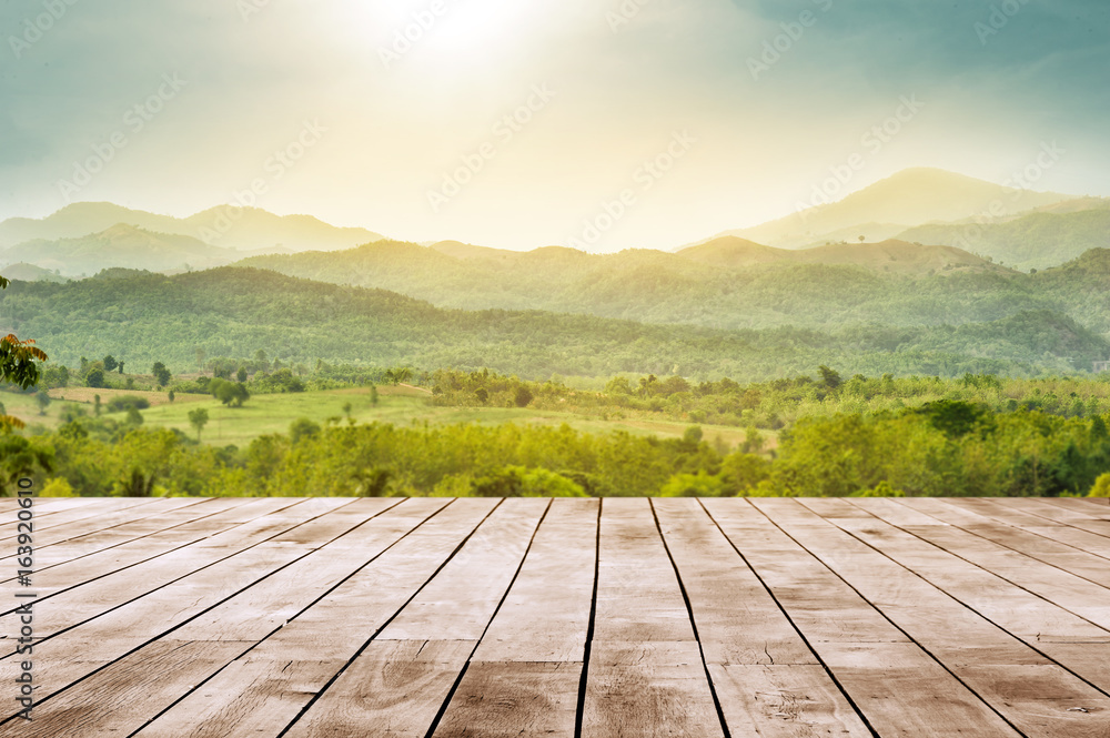 wooden table top with the mountain landscape - obrazy, fototapety, plakaty 