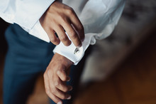The Groom Fastens The Cufflink On The Shirt Sleeve Close-up
