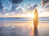 Fototapeta Boho - Surfboard on the beach at sunset