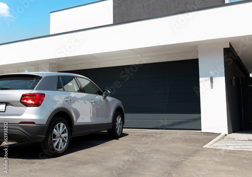 Car In Front Of Modern House Waiting To Enter In The Garage