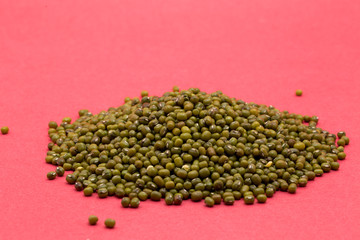 A pile of moong isolated on a red background